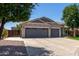 Home with three-car garage, extensive driveway and gravel landscaping, with additional parking behind a wooden gate at 34970 N Spur Cir, San Tan Valley, AZ 85144