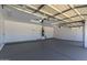 Spacious, clean garage featuring an epoxy floor and ample space for vehicles and storage at 34970 N Spur Cir, San Tan Valley, AZ 85144
