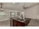 Kitchen island features a dual sink, stainless steel dishwasher, dark countertops, and distressed wood at 34970 N Spur Cir, San Tan Valley, AZ 85144