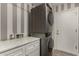 Laundry room featuring a stackable washer and dryer and marble countertop at 34970 N Spur Cir, San Tan Valley, AZ 85144