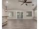 Bright living area featuring wood-look floors, a sliding glass door for natural light, and a breakfast bar at 34970 N Spur Cir, San Tan Valley, AZ 85144