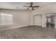 Spacious living room with wood-look tile, archway accents, and great natural light, perfect for relaxing at 34970 N Spur Cir, San Tan Valley, AZ 85144