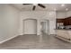 Spacious living room features wood-look tile flooring, neutral paint, and a ceiling fan at 34970 N Spur Cir, San Tan Valley, AZ 85144