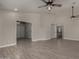 Expansive living area featuring neutral tones, wood-look tile, and seamless transitions to other rooms and spaces at 34970 N Spur Cir, San Tan Valley, AZ 85144