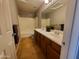 This bathroom features a wood cabinet vanity with dual sinks, tile floors, and a shower/tub combo at 351 S Apache Dr, Chandler, AZ 85224