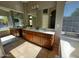 Bright bathroom with a double sink vanity, mirror, tile floor, garden tub and natural light at 351 S Apache Dr, Chandler, AZ 85224