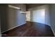 This bedroom features dark wood floors, floating shelves, and a closet with white sliding doors at 351 S Apache Dr, Chandler, AZ 85224