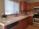 Charming kitchen features bright natural light, wooden cabinets and white tile countertops at 351 S Apache Dr, Chandler, AZ 85224