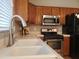 Well-lit kitchen featuring wooden cabinets, stainless steel appliances, and a double basin sink at 351 S Apache Dr, Chandler, AZ 85224