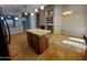 Open-concept living space with kitchen island, fireplace, tile flooring and a neutral color palette at 351 S Apache Dr, Chandler, AZ 85224