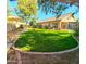 Well-maintained backyard featuring lush green grass, mature trees, and an outdoor living space at 3823 E Kroll Dr, Gilbert, AZ 85234