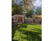 Beautifully maintained backyard with a storage shed, mature trees, and an irrigation system at 3823 E Kroll Dr, Gilbert, AZ 85234