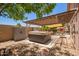 Relaxing backyard with covered hot tub and outdoor storage, creating a serene and functional space at 3823 E Kroll Dr, Gilbert, AZ 85234