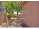 Backyard view, showcasing the outdoor shower, additional storage and manicured, low maintenance desert landscaping at 3823 E Kroll Dr, Gilbert, AZ 85234