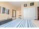A bedroom with neutral walls, laminate floors, and a view to the bathroom at 3823 E Kroll Dr, Gilbert, AZ 85234