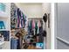 A closet features wood laminate flooring, shelving, hanging rods, and ample storage space at 3823 E Kroll Dr, Gilbert, AZ 85234