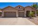 Charming single-story home featuring a three-car garage, desert landscaping, and neutral stucco facade at 3823 E Kroll Dr, Gilbert, AZ 85234