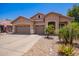 Charming single-story home featuring a three-car garage, desert landscaping, and neutral stucco facade at 3823 E Kroll Dr, Gilbert, AZ 85234