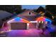Festively decorated exterior view of home with a three-car garage and manicured landscaping at 3823 E Kroll Dr, Gilbert, AZ 85234