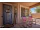 Inviting front porch with rocking chairs, decorative wreath, and a cozy welcome mat at 3823 E Kroll Dr, Gilbert, AZ 85234