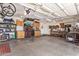 Spacious garage with storage cabinets, workshop area, and organized tools at 3823 E Kroll Dr, Gilbert, AZ 85234