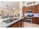 Modern kitchen featuring granite countertops, stainless steel appliances, and an island with a sink at 3823 E Kroll Dr, Gilbert, AZ 85234