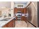 This kitchen offers stainless appliances, granite countertops, dark wood cabinetry, and lots of natural light at 3823 E Kroll Dr, Gilbert, AZ 85234
