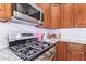 A kitchen featuring stainless appliances, granite countertops, tile backsplash, and dark wood cabinetry at 3823 E Kroll Dr, Gilbert, AZ 85234