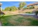 View of the backyard with a green lawn, a refreshing pool, and a classic block wall ensuring privacy at 4002 E Agave Rd, Phoenix, AZ 85044