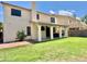 Expansive backyard with a covered patio, well-maintained lawn, and the home's exterior at 4002 E Agave Rd, Phoenix, AZ 85044