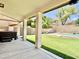 Covered patio showcasing a spacious backyard with lush lawn and a sparkling pool at 4002 E Agave Rd, Phoenix, AZ 85044