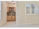 Charming bar area with custom cabinets and mosaic backsplash, located off the main living space at 4002 E Agave Rd, Phoenix, AZ 85044