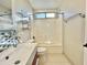Updated bathroom featuring a modern vanity, blue backsplash, and a shower-tub combination at 4002 E Agave Rd, Phoenix, AZ 85044