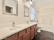 Well-lit bathroom featuring double sinks, wood cabinetry, and a shower-tub combination at 4002 E Agave Rd, Phoenix, AZ 85044