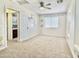 Bright bedroom featuring carpeted floors, neutral walls with fun, themed painted designs, and an ensuite bathroom at 4002 E Agave Rd, Phoenix, AZ 85044