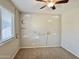 Carpeted bedroom featuring neutral walls with moon, stars, and Dream-themed decorations, and a ceiling fan at 4002 E Agave Rd, Phoenix, AZ 85044