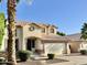 Exterior elevation of a two-story home featuring a tile roof, a two-car garage, and manicured landscaping at 4002 E Agave Rd, Phoenix, AZ 85044