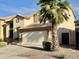 Charming two-story home showcasing a well-maintained lawn, a two-car garage, and a palm tree at 4002 E Agave Rd, Phoenix, AZ 85044