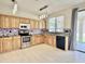 Well-equipped kitchen featuring stainless steel appliances and warm wood cabinetry at 4002 E Agave Rd, Phoenix, AZ 85044