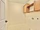 Laundry room featuring tile flooring, overhead cabinets, and utility connections at 4002 E Agave Rd, Phoenix, AZ 85044
