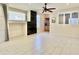 Bright living room featuring white tiled floors, stone fireplace and views to another room at 4002 E Agave Rd, Phoenix, AZ 85044