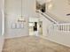 Bright living room features a modern chandelier, high ceilings and staircase leading to the second level at 4002 E Agave Rd, Phoenix, AZ 85044