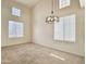 Bright living room boasting soaring ceilings, ample natural light, and contemporary chandelier at 4002 E Agave Rd, Phoenix, AZ 85044