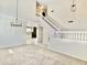 Spacious living room with neutral carpet, chandelier, staircase, and an inviting open layout at 4002 E Agave Rd, Phoenix, AZ 85044