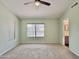 Bright main bedroom featuring a ceiling fan and en suite bathroom at 4002 E Agave Rd, Phoenix, AZ 85044