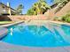 Backyard pool featuring cool blue water and a textured border, surrounded by desert landscaping at 4002 E Agave Rd, Phoenix, AZ 85044