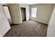 Bedroom with neutral carpet, a sliding door closet, and natural light at 43890 W Bedford Dr, Maricopa, AZ 85138