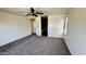 Empty bedroom with neutral carpet, a ceiling fan, and ample natural light at 43890 W Bedford Dr, Maricopa, AZ 85138