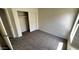 Bright bedroom with neutral carpet and a sliding door closet at 43890 W Bedford Dr, Maricopa, AZ 85138