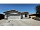 Charming single-story home with a two-car garage, desert landscaping and a tile roof at 43890 W Bedford Dr, Maricopa, AZ 85138